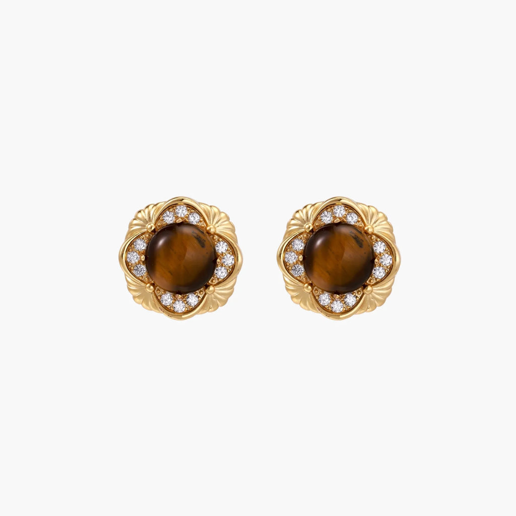 Gold-plated stud earrings with ornate floral frames surrounding cabochon tiger's eye stones and zirconia accents