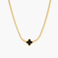 Dainty 18K gold-plated herringbone chain necklace with black enamel quatrefoil clover pendant on white background