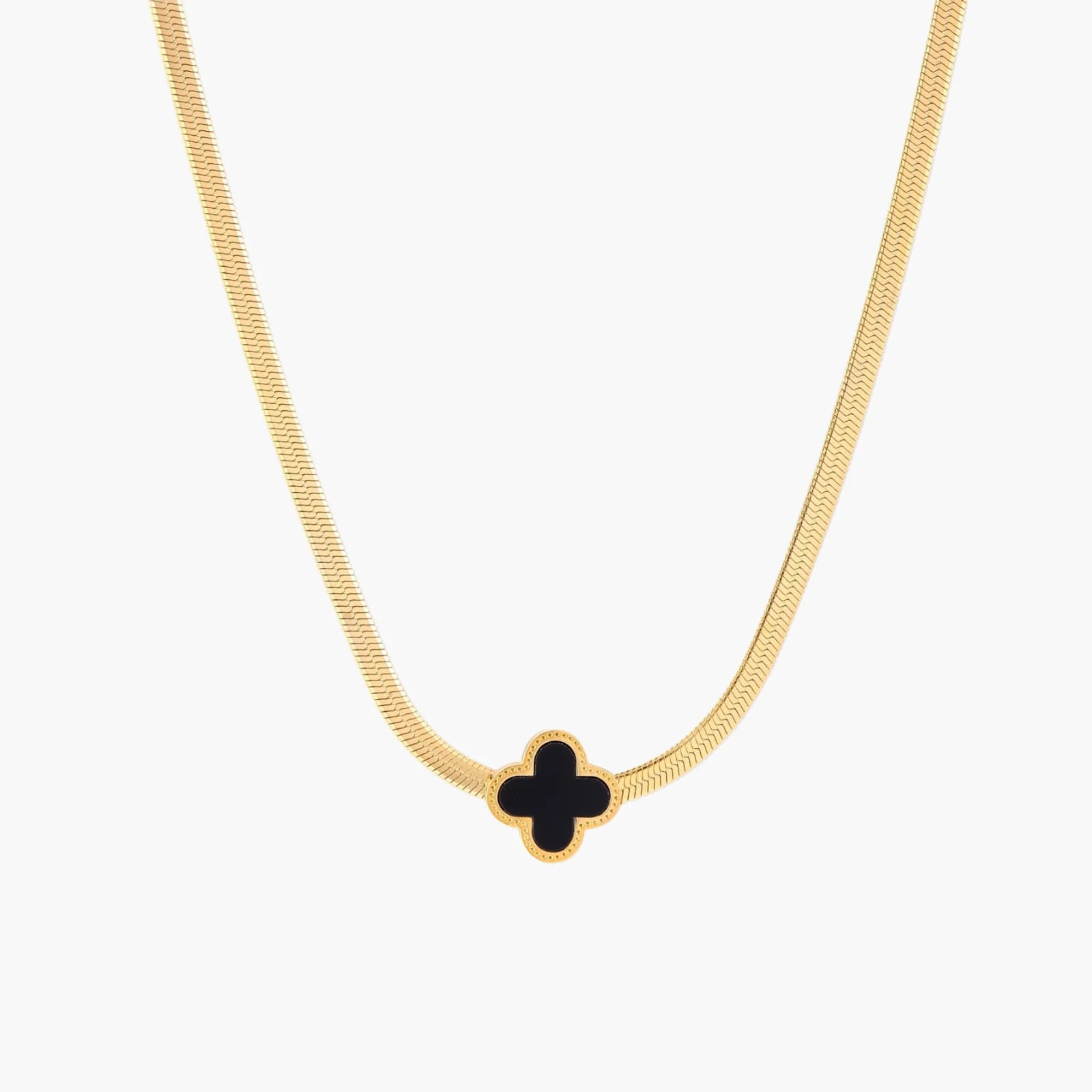 Dainty 18K gold-plated herringbone chain necklace with black enamel quatrefoil clover pendant on white background