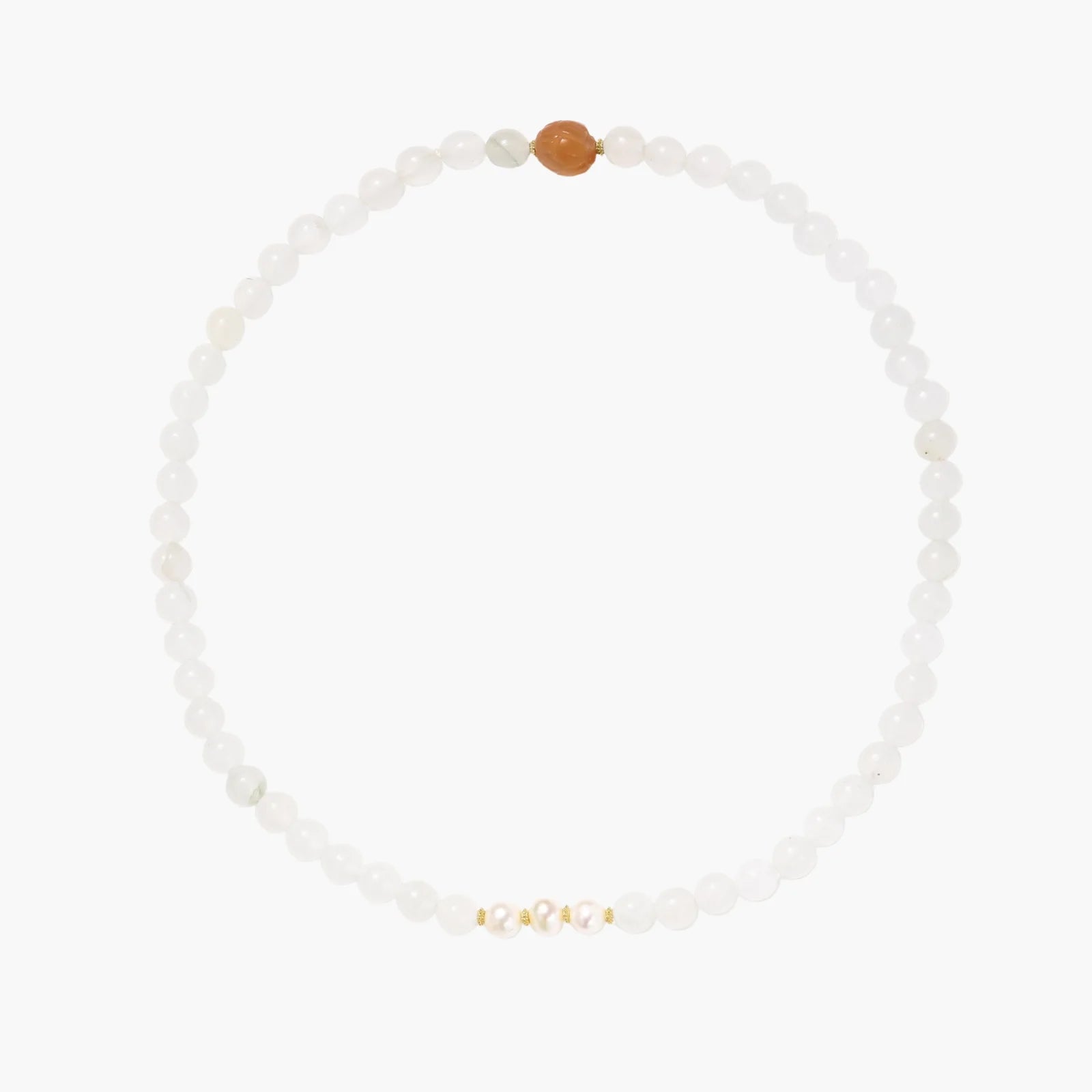 Three layered white beaded bracelets with carved orange agate lotus centerpiece and freshwater pearls on cream background.
