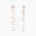 Long sterling silver drop earrings with delicate floral vine design and crystal accents on white background