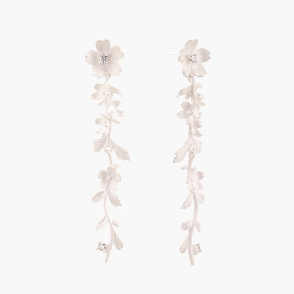 Long sterling silver drop earrings with delicate floral vine design and crystal accents on white background