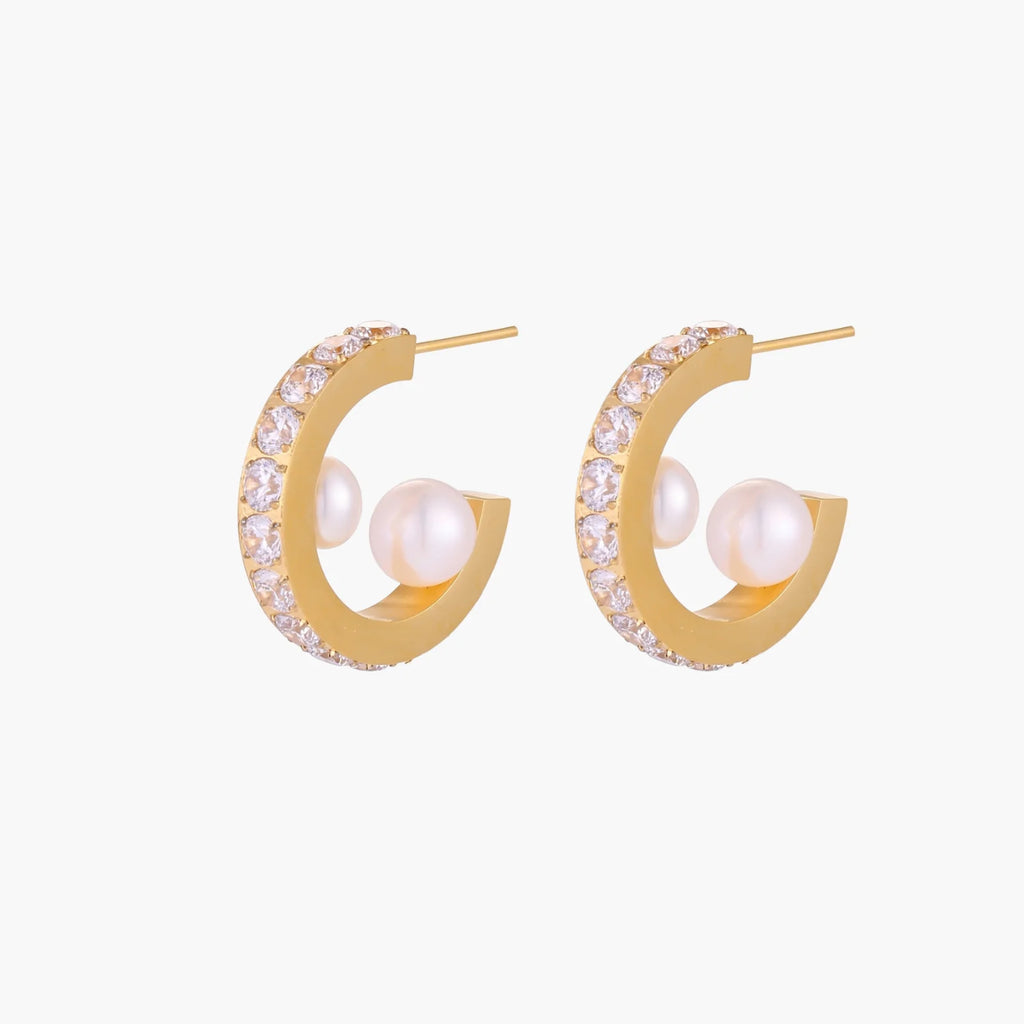 Gold pavé hoop earrings with two freshwater pearls nestled inside the curved design, featuring crystal-studded outer edge.