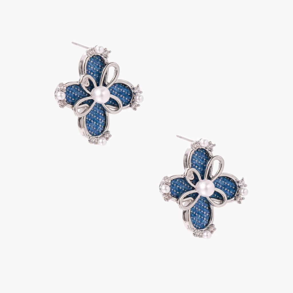 Blue denim fabric flower studs with white gold plated petals, pearl center, and zirconia accents on white background