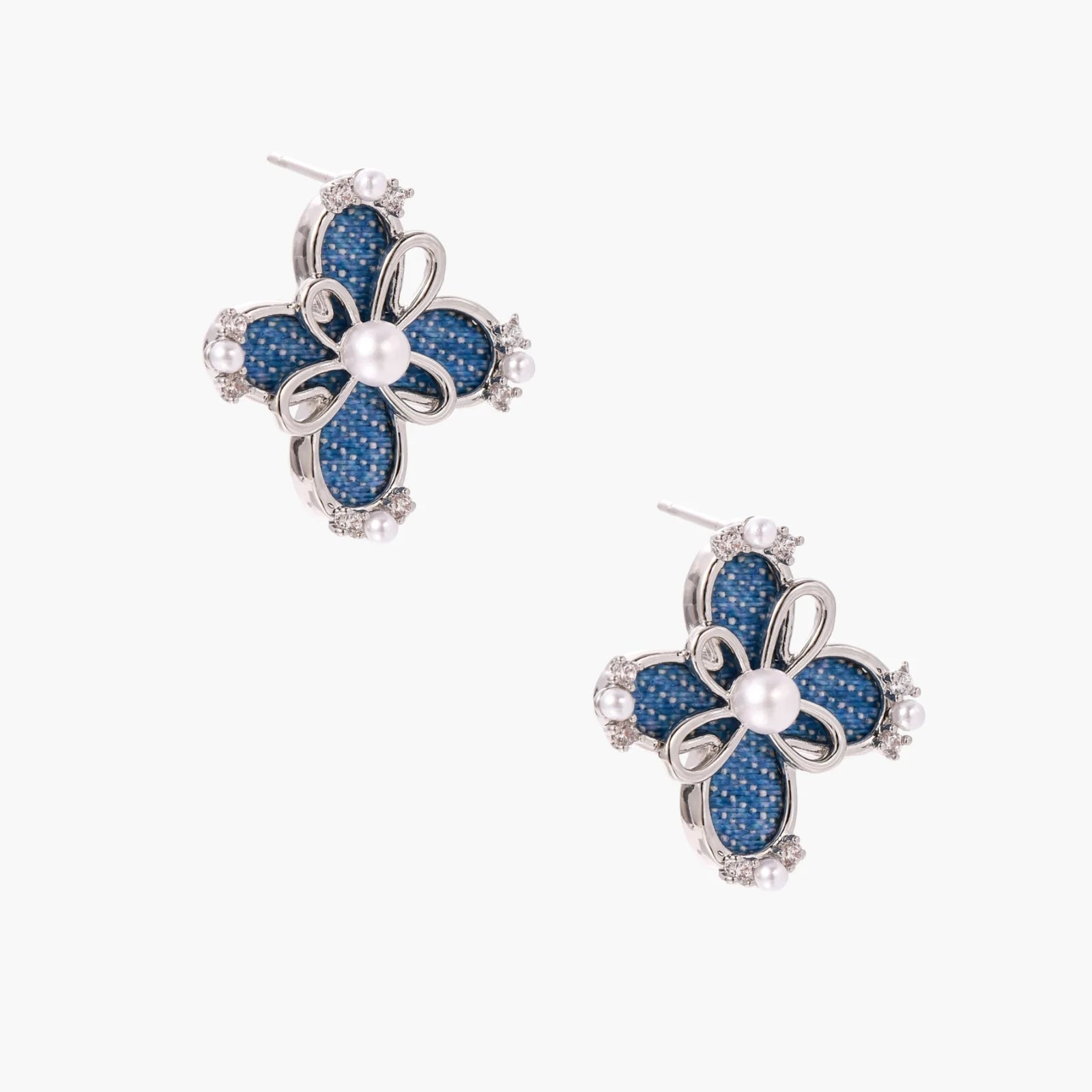Blue denim fabric flower studs with white gold plated petals, pearl center, and zirconia accents on white background