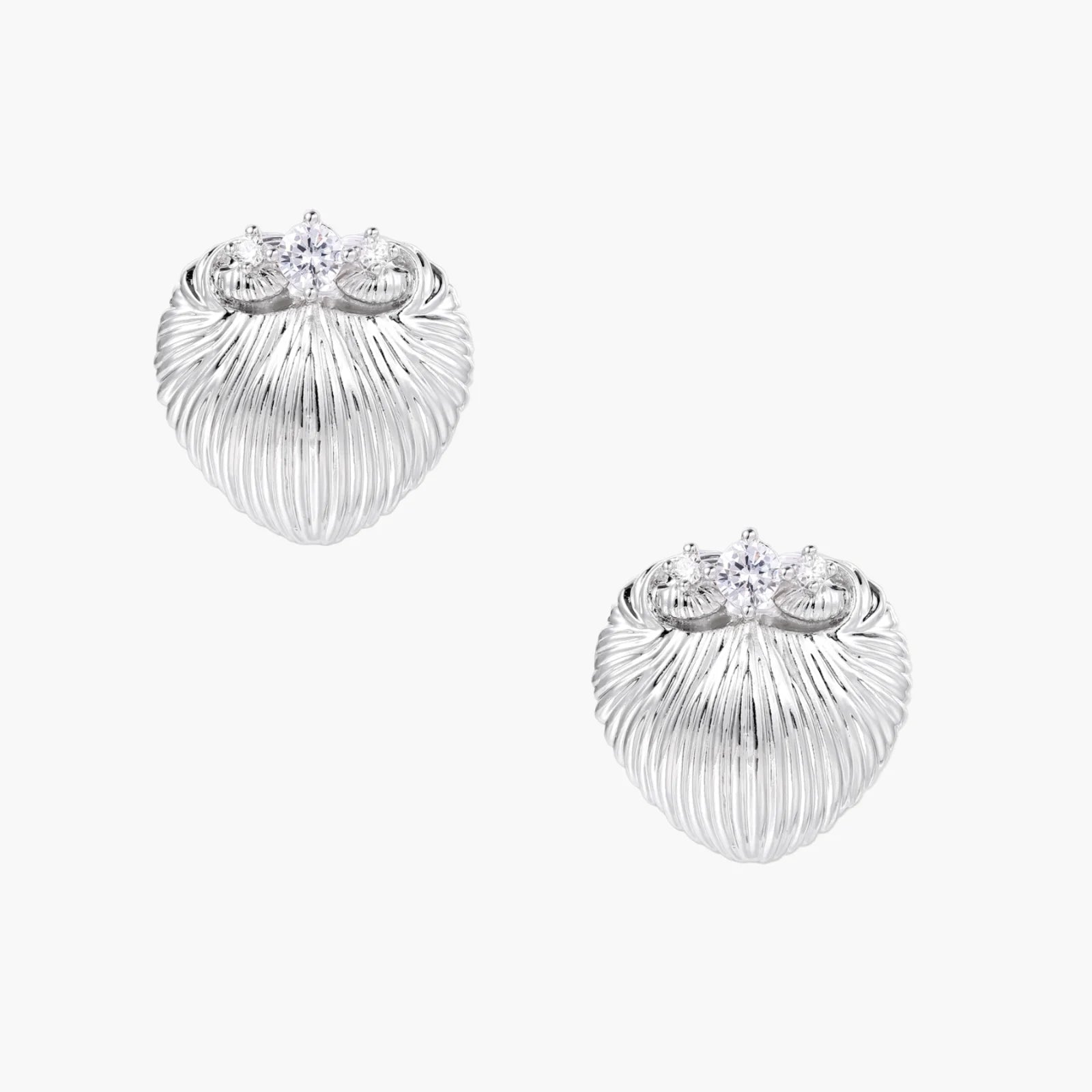 White gold-plated shell-textured stud earrings with three zirconia crystals on ridged surface against cream background.