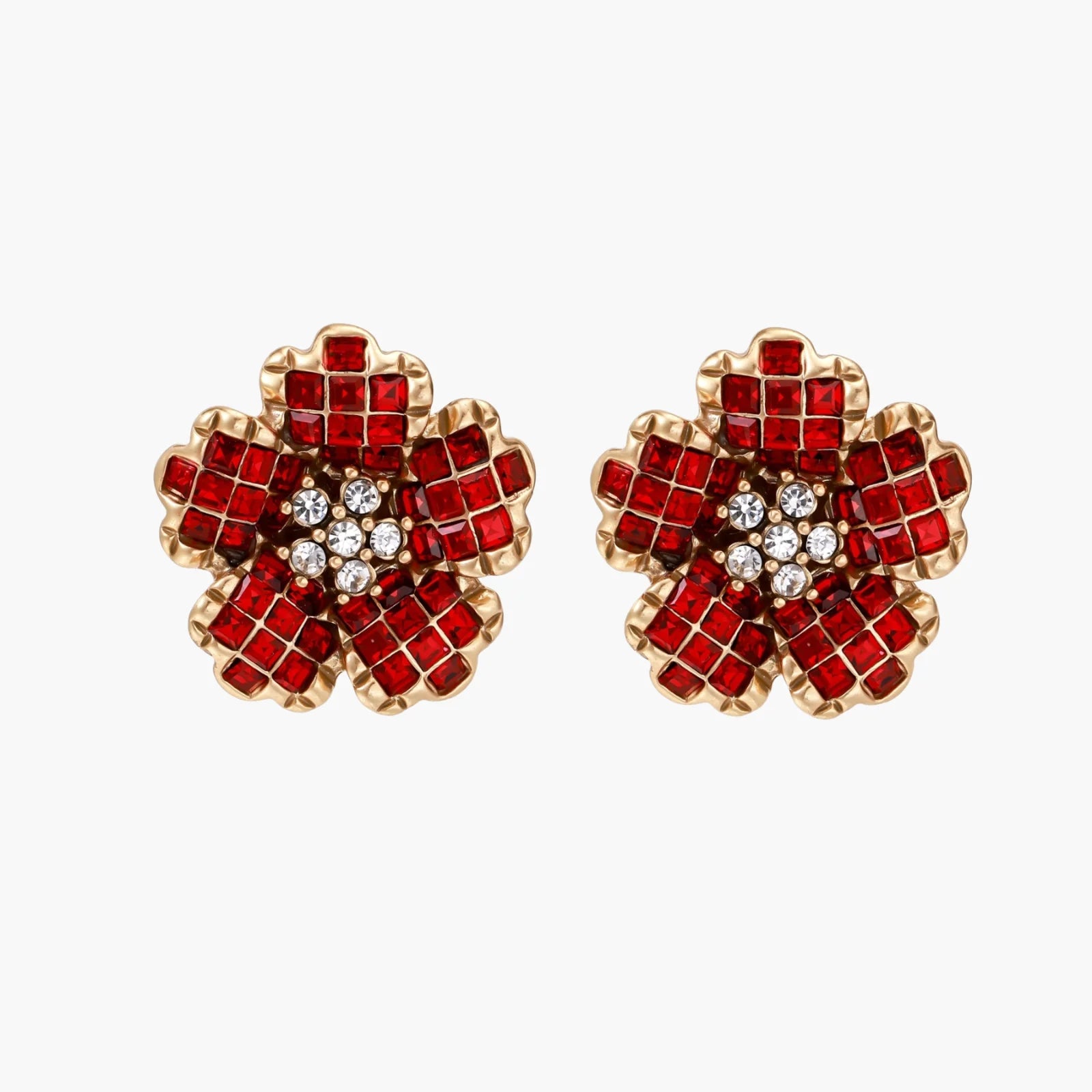 Gold-plated flower studs with burgundy square crystals in petal mosaic and clear center stones on beige background.