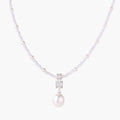 Dainty necklace with lavender crystal beads, freshwater pearls, geometric pendant, and large pearl drop on white background.
