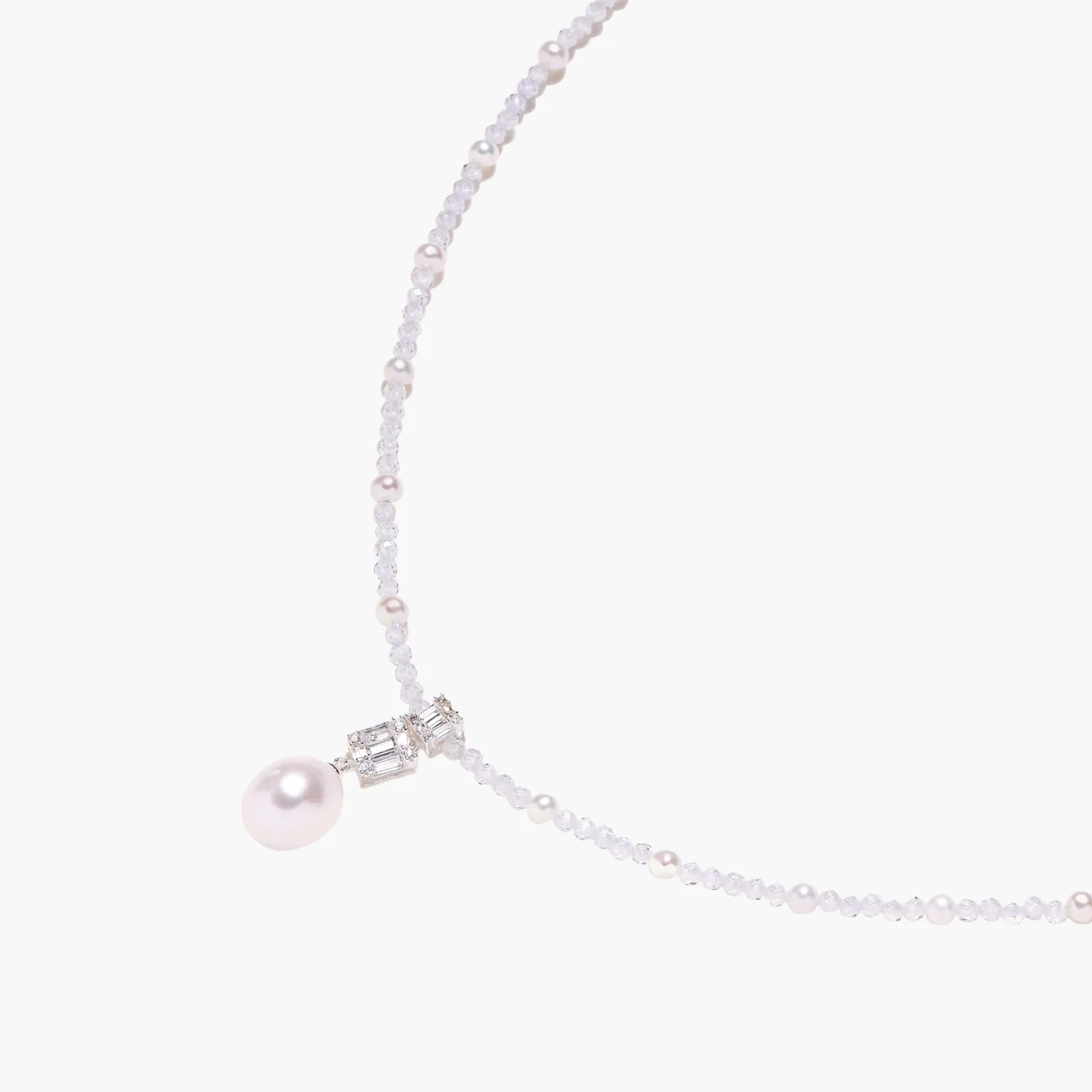 Dainty necklace with lavender crystal beads, freshwater pearls, geometric pendant, and large pearl drop on white background.
