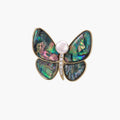 Gold-plated butterfly brooch with iridescent abalone shell wings and freshwater pearl accent on cream background.