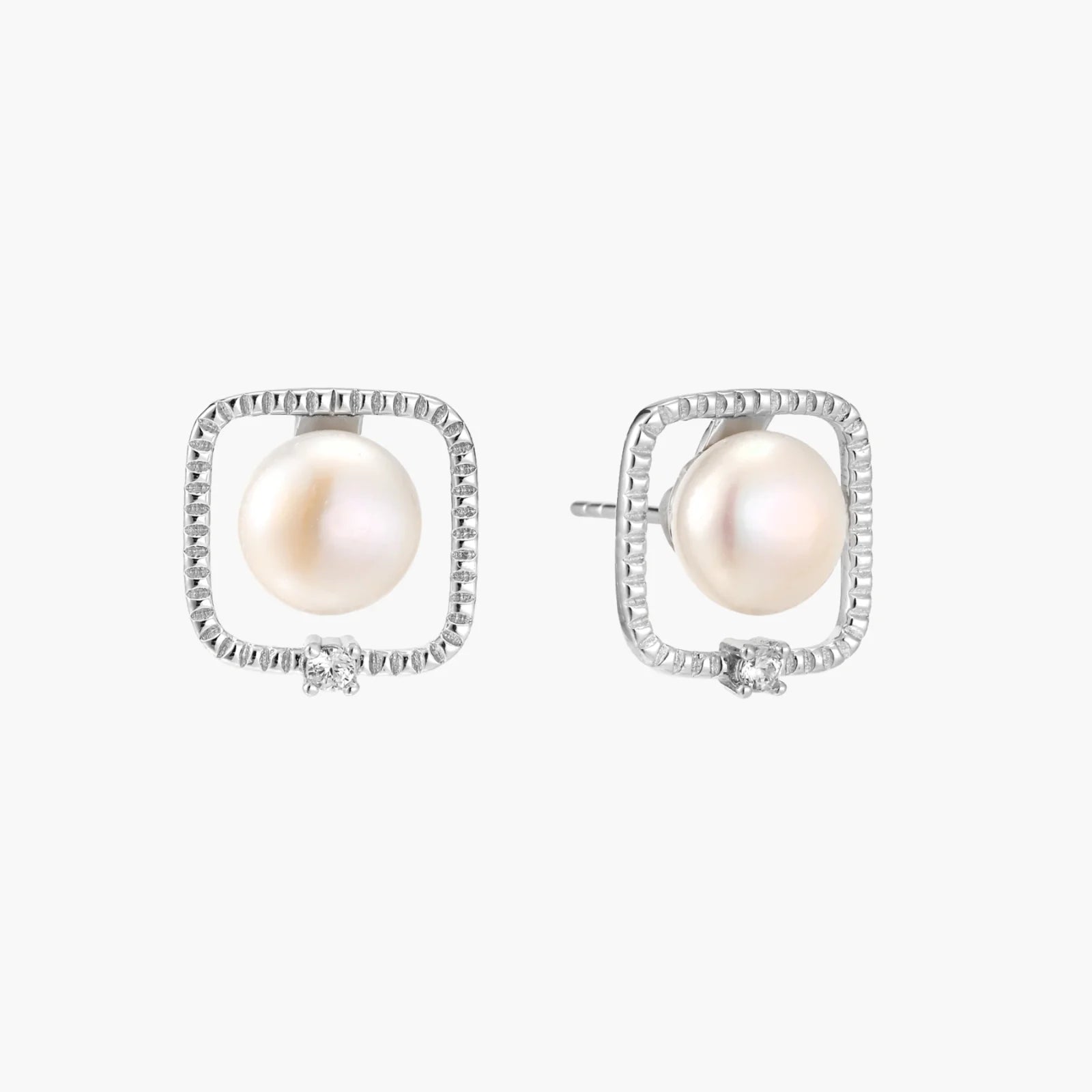 Rhodium-plated silver stud earrings with cushion frame, centered freshwater pearl, and tiny crystal accent