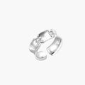 Adjustable silver-toned ring with sculptural stitch design across polished white gold-plated brass band