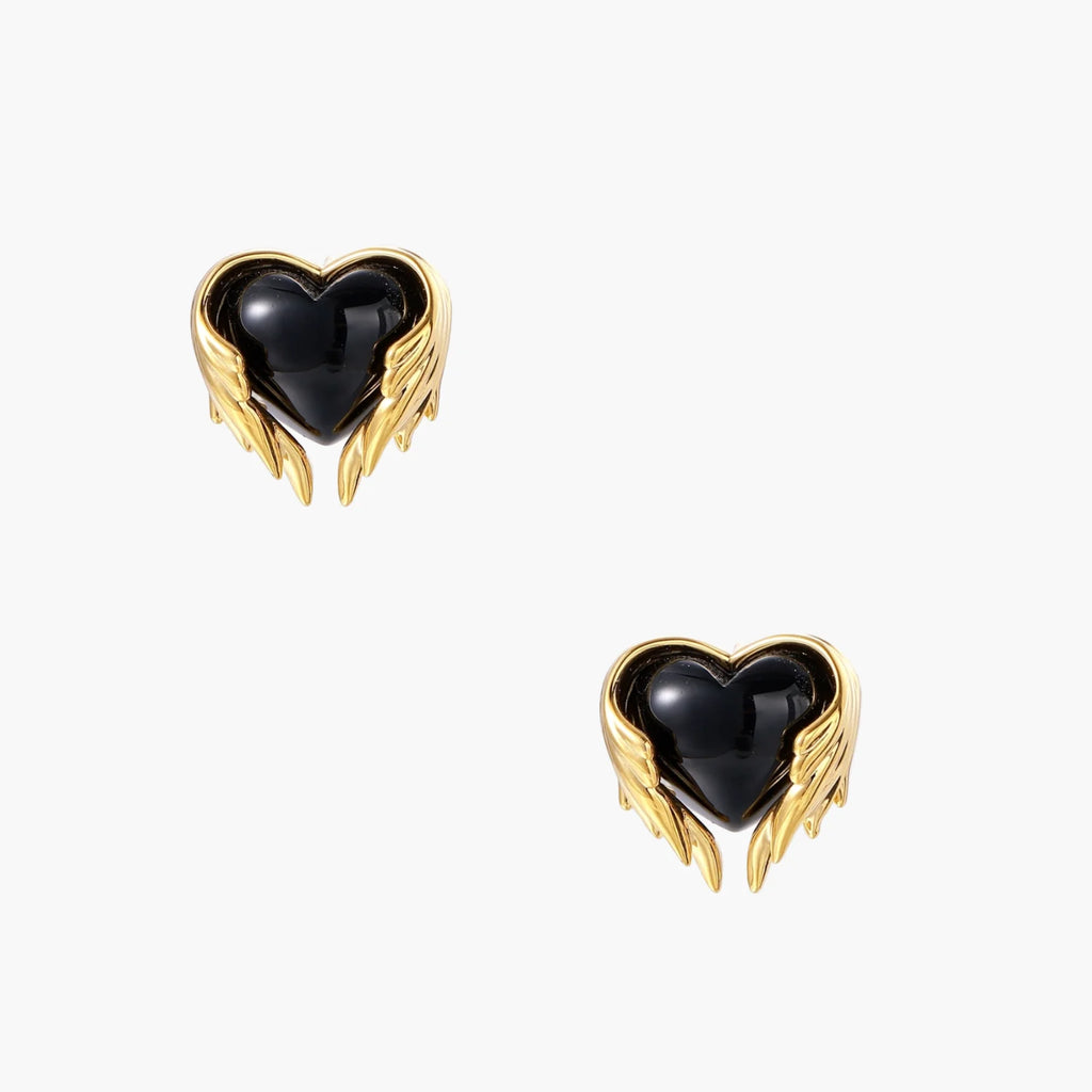 Glossy black heart-shaped studs with gold wing accents on cream background, gothic romantic style earrings