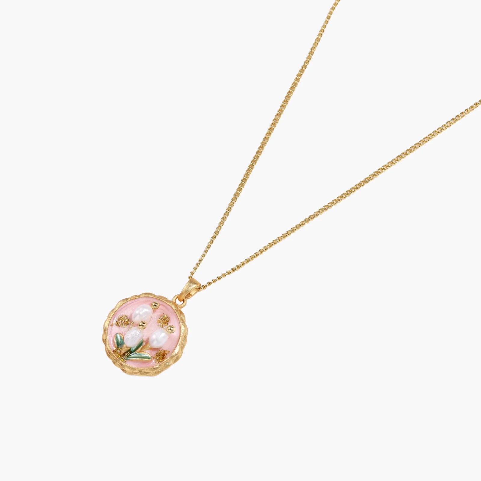 Gold pendant with pink enamel backdrop, white freshwater pearls as tulip blooms, and green leaf accents on rope chain.