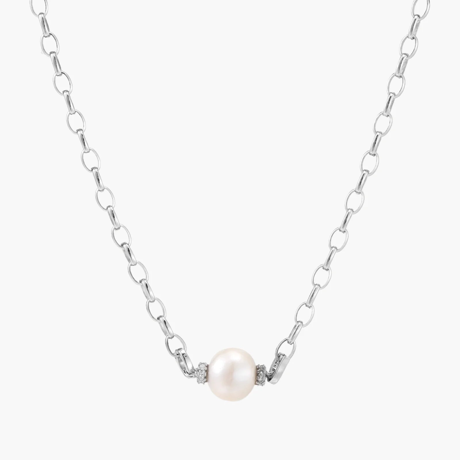 Dainty rhodium-plated silver chain necklace with centered 10mm freshwater pearl and crystal accents on cream background