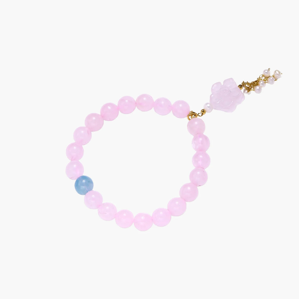 Stretchy beaded bracelet with pink rose quartz, blue aquamarine, carved floral pendant, and pearl tassel clasp.