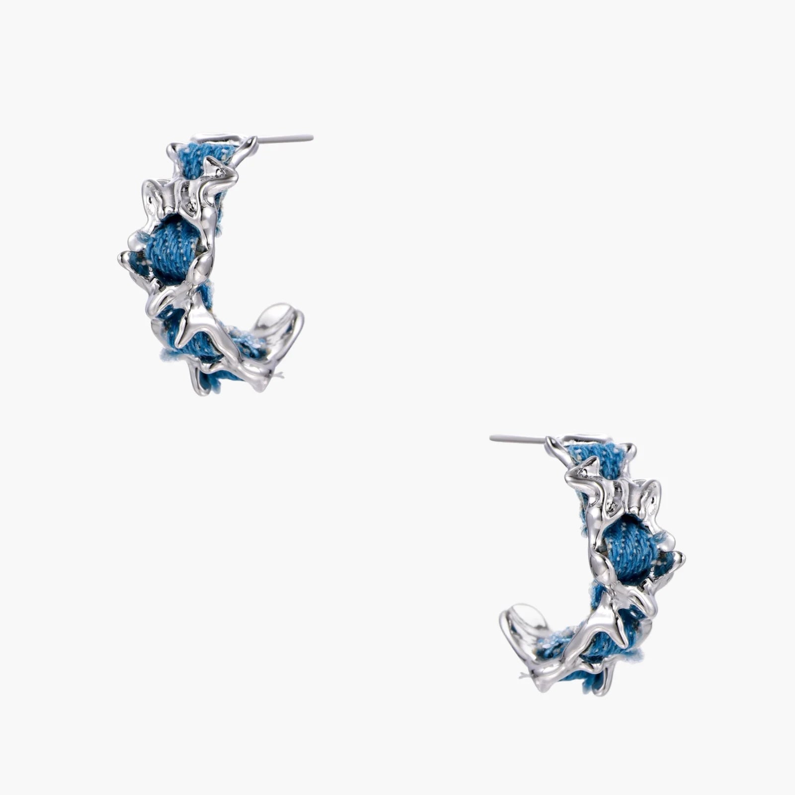 White gold plated hoop earrings with woven blue denim fabric through organic branch-like metal framework
