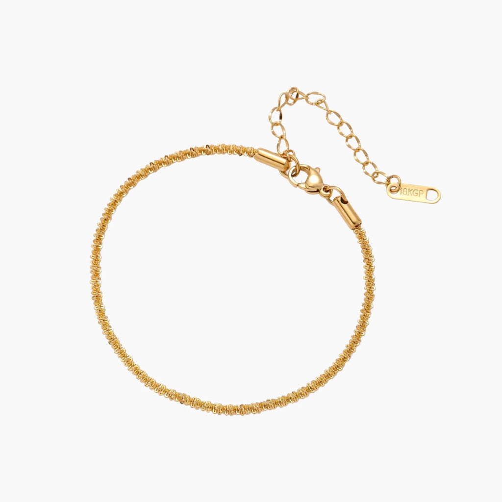 Delicate 18K gold-plated stainless steel bracelet with textured beaded chain on cream background