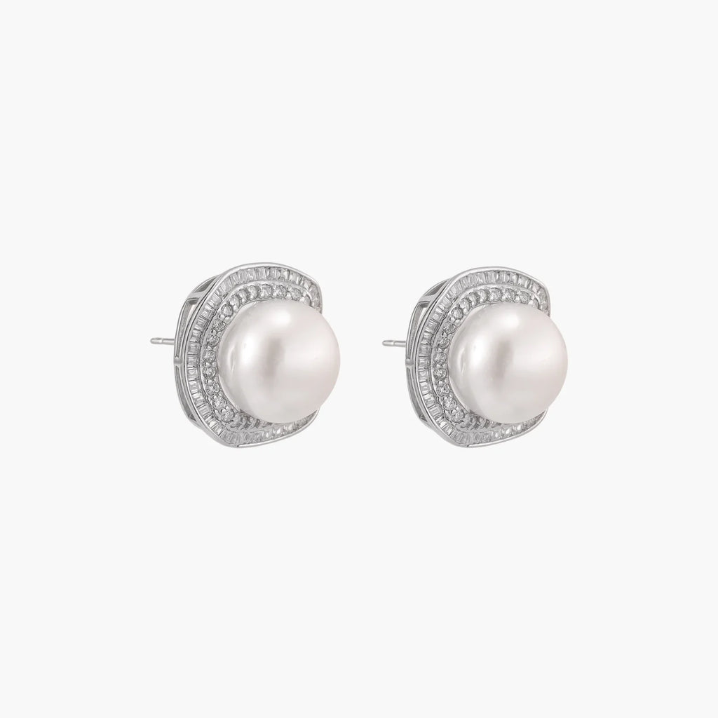 Cushion-shaped sterling silver stud earrings with freshwater pearls surrounded by geometric diamond halos